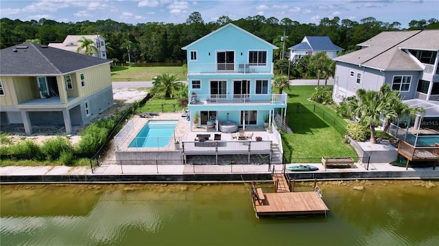 back of house featuring a water view, a balcony, an outdoor hangout area, and a patio