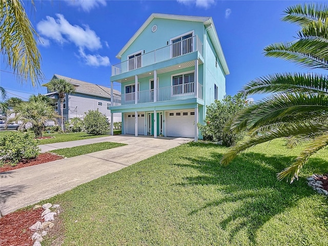 beach home with a garage, a balcony, and a front yard