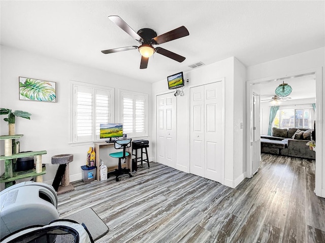 office with hardwood / wood-style flooring and ceiling fan