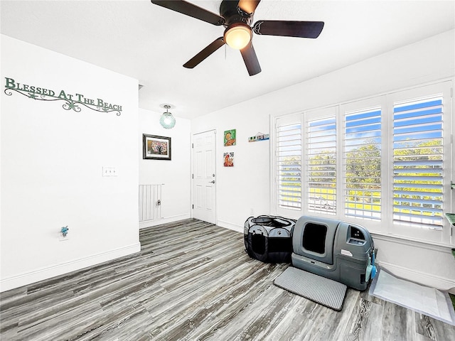 sitting room with hardwood / wood-style flooring, a healthy amount of sunlight, and ceiling fan