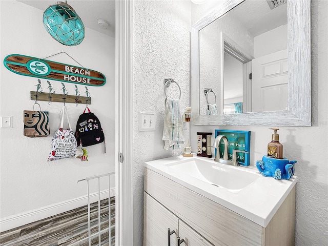 bathroom with hardwood / wood-style flooring and vanity