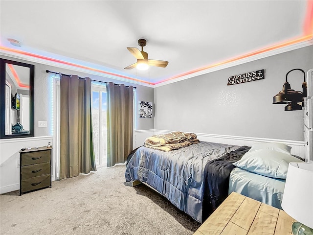 bedroom with crown molding, ceiling fan, and carpet flooring