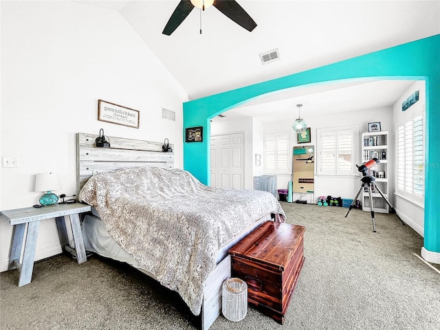 bedroom with lofted ceiling, carpet floors, a closet, and ceiling fan