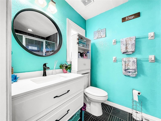 bathroom with vanity, toilet, a shower with door, and tile patterned flooring