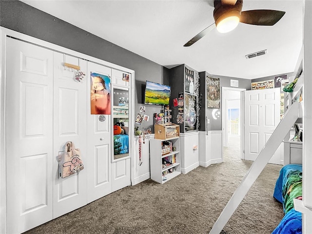 interior space featuring ceiling fan and carpet