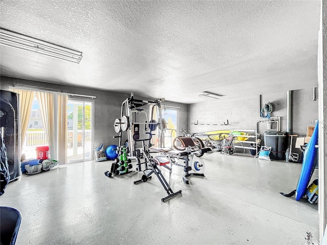 exercise area featuring a wealth of natural light and a textured ceiling