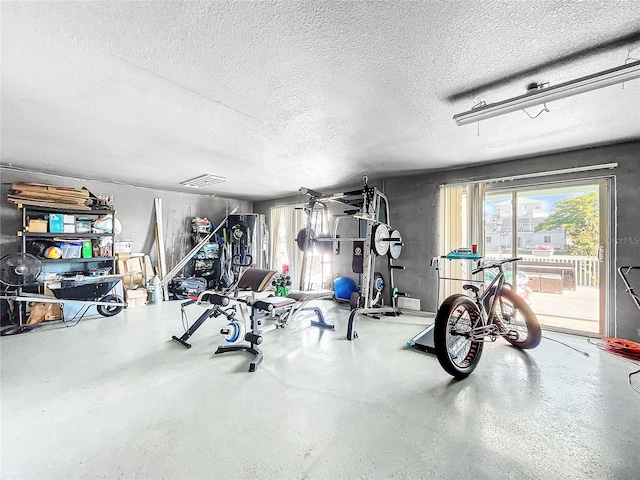 workout room featuring a textured ceiling