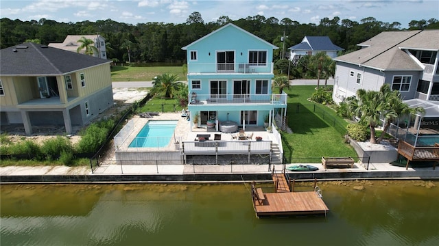 back of house with a patio, a balcony, and a water view