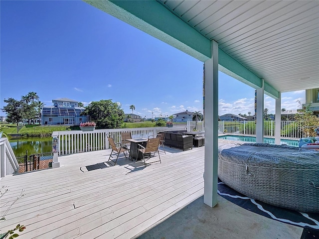 deck with a water view, an outdoor living space, and a fenced in pool