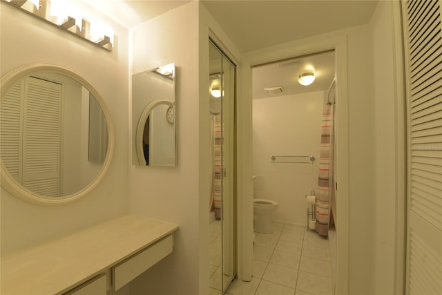 bathroom featuring vanity, toilet, and tile patterned floors