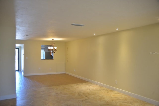 empty room featuring a chandelier