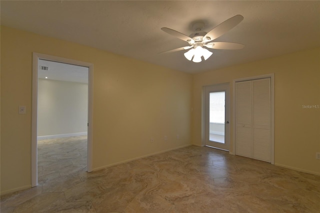 tiled empty room featuring ceiling fan