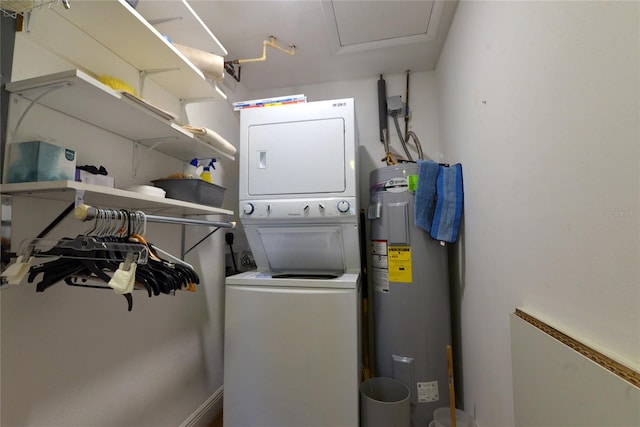 washroom featuring electric water heater and stacked washer and clothes dryer