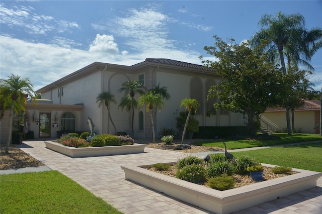 view of side of home with a lawn