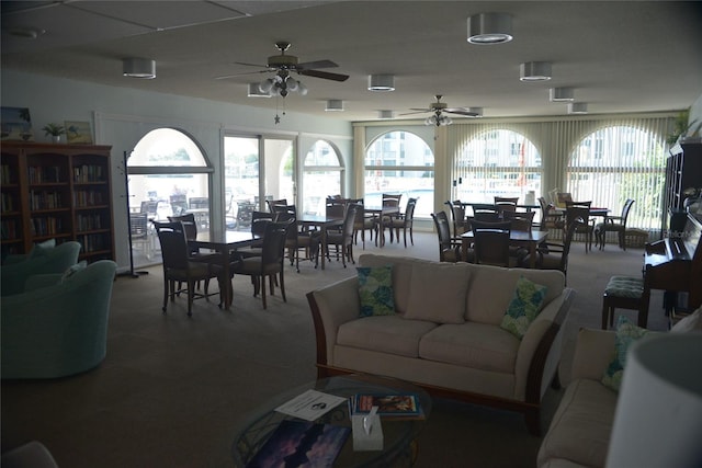 living room featuring carpet and ceiling fan