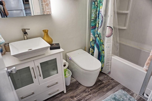 full bathroom featuring shower / tub combo, vanity, wood-type flooring, and toilet