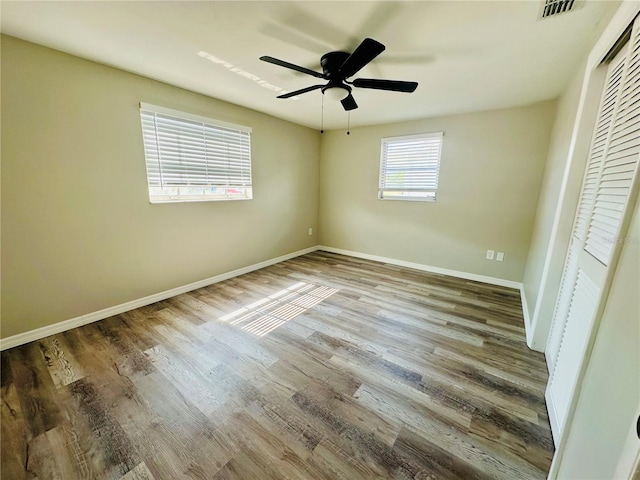 unfurnished bedroom featuring ceiling fan, hardwood / wood-style floors, and a closet