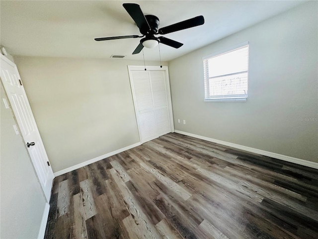 unfurnished bedroom with a closet, hardwood / wood-style floors, and ceiling fan