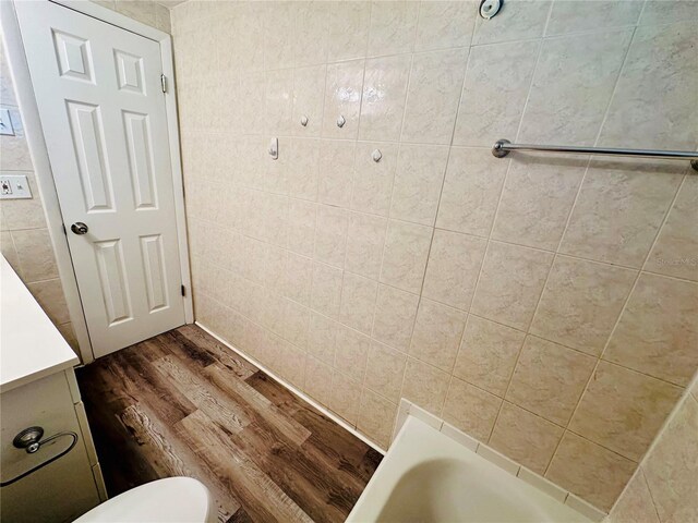 bathroom with vanity, toilet, and hardwood / wood-style floors