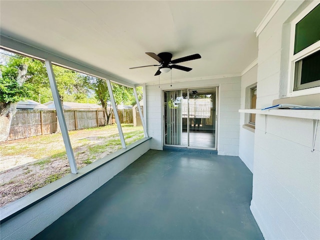 unfurnished sunroom featuring a wealth of natural light and ceiling fan