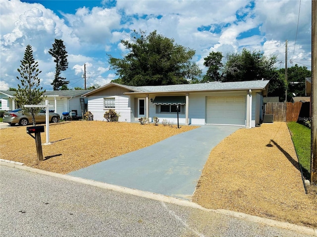 single story home with a garage and a front lawn