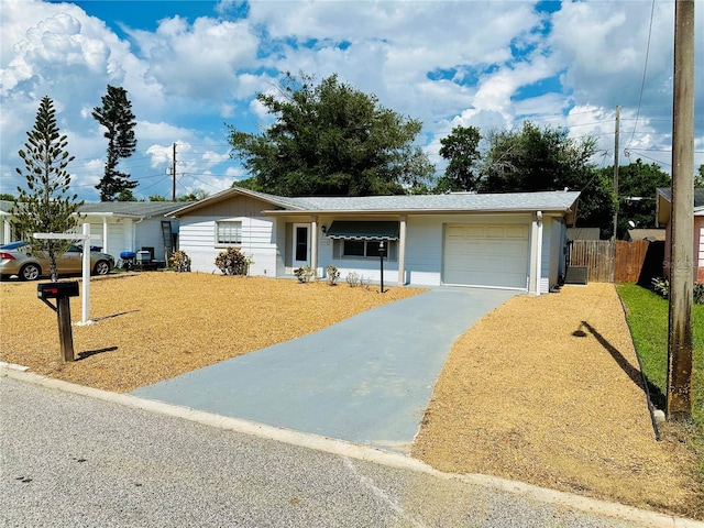 single story home featuring a garage and a front yard