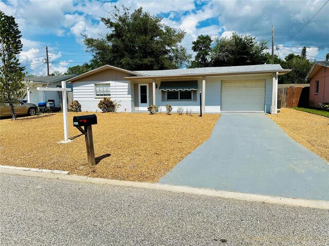 ranch-style house featuring a garage and a front yard