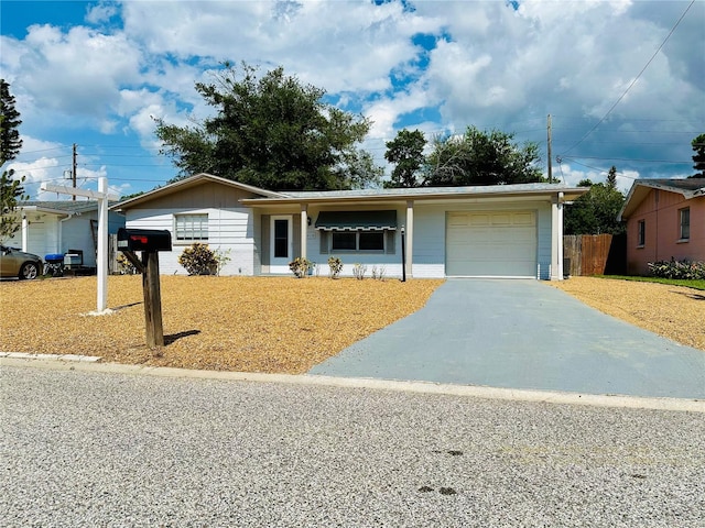 ranch-style house with a garage and a front yard