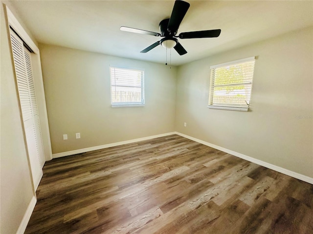 unfurnished bedroom with a closet, wood-type flooring, and ceiling fan