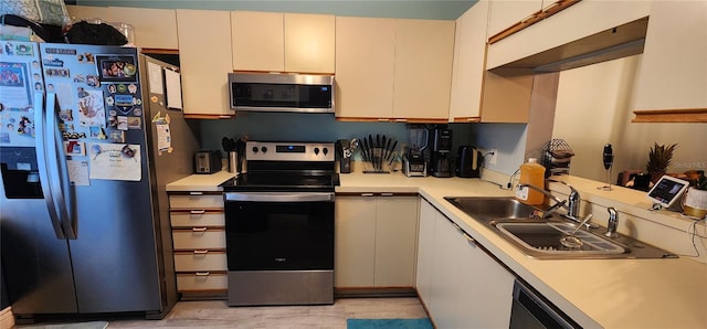 kitchen featuring sink, appliances with stainless steel finishes, and light wood-type flooring