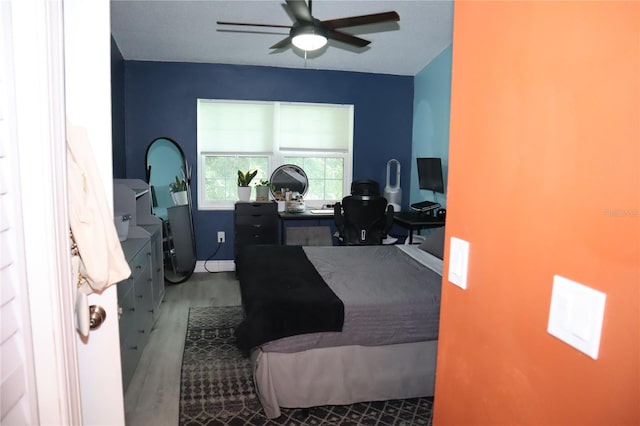 bedroom featuring ceiling fan and hardwood / wood-style floors