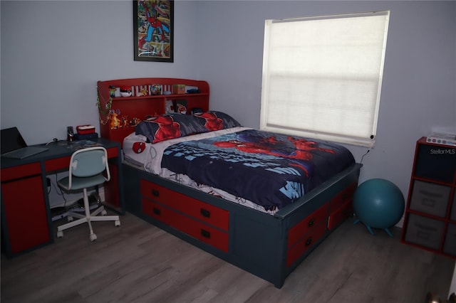 bedroom with hardwood / wood-style floors