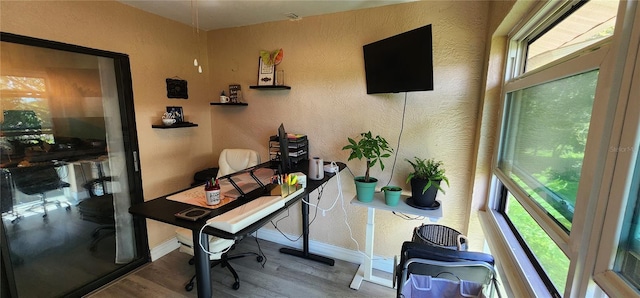 home office with wood-type flooring