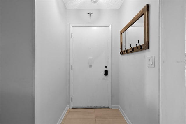 doorway with light tile patterned floors