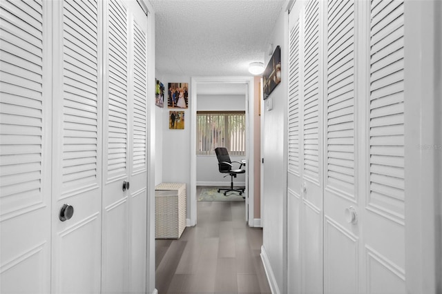 hall with a textured ceiling