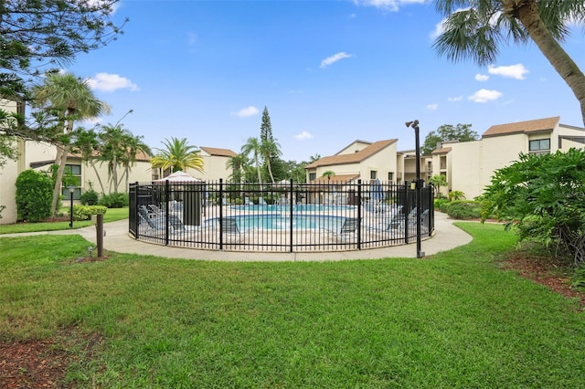 view of pool with a lawn