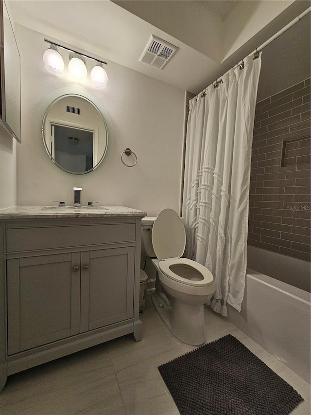 full bathroom featuring tile patterned floors, toilet, shower / bath combination with curtain, and vanity