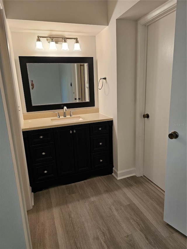 bathroom with vanity and hardwood / wood-style flooring