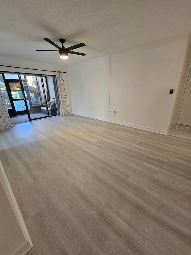 unfurnished room with a textured ceiling, ceiling fan, and light hardwood / wood-style floors