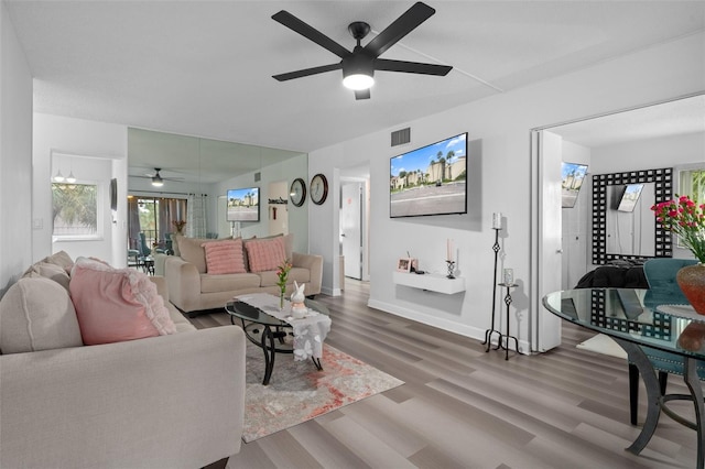 2207 Belleair Rd Unit A32, Clearwater, FL 33764 - living area featuring a ceiling fan, wood finished floors, and baseboards