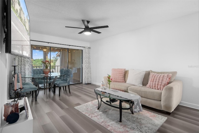 2207 Belleair Rd Unit A32, Clearwater, FL 33764 - living area featuring baseboards, a ceiling fan, and wood finished floors