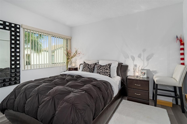 2207 Belleair Rd Unit A32, Clearwater, FL 33764 - bedroom featuring wood finished floors and a textured ceiling