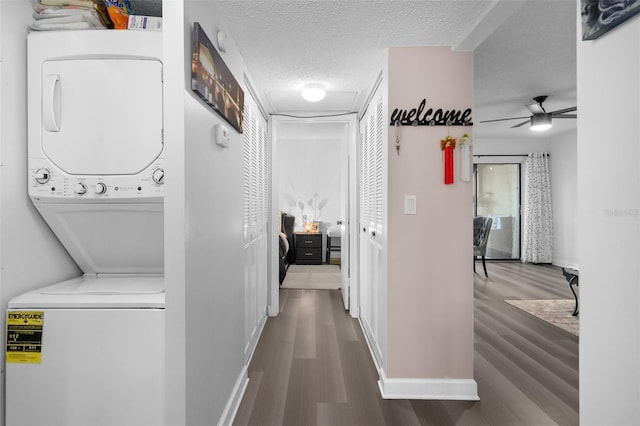 2207 Belleair Rd Unit A32, Clearwater, FL 33764 - laundry room with stacked washer / dryer, wood finished floors, baseboards, ceiling fan, and a textured ceiling