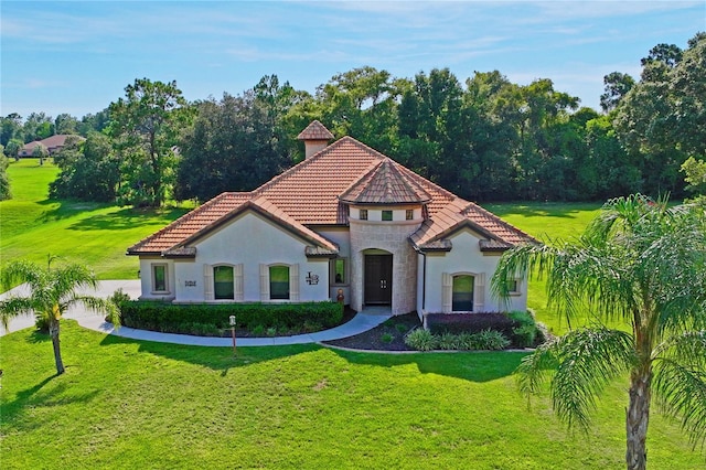 mediterranean / spanish house featuring a front yard