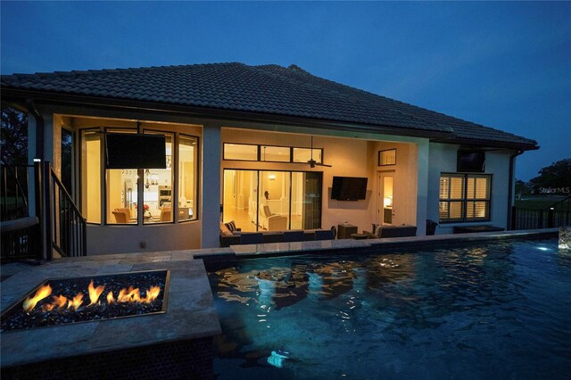 view of swimming pool featuring a patio and an outdoor fire pit