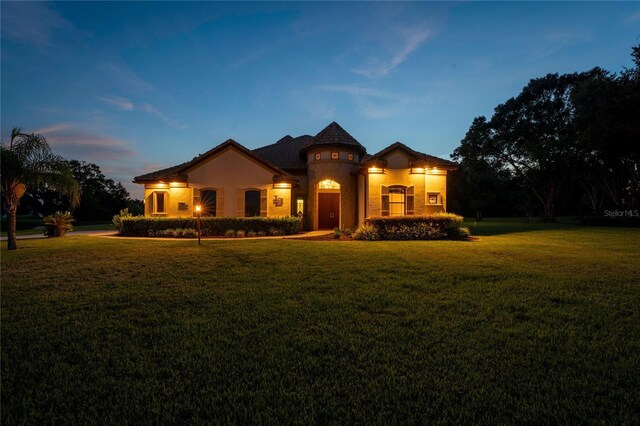 mediterranean / spanish-style house featuring a yard