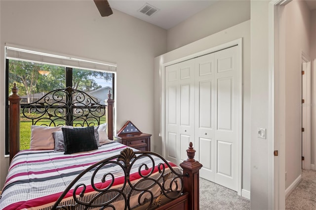 bedroom with light colored carpet, a closet, and ceiling fan