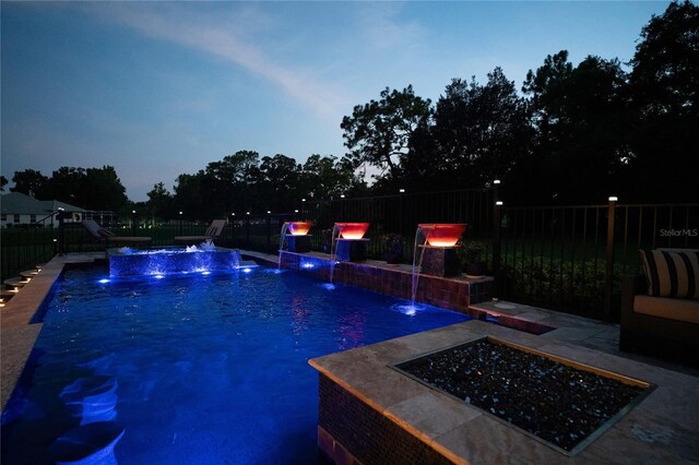 view of swimming pool with a patio area and pool water feature