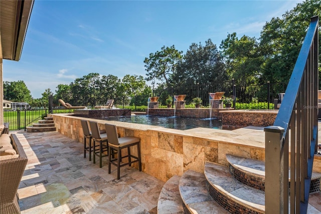 view of patio with an outdoor bar