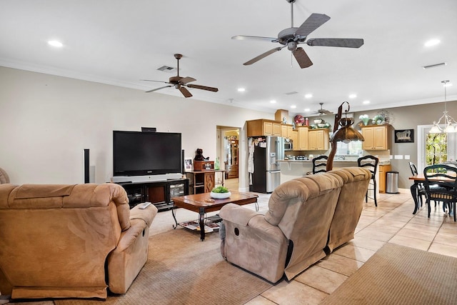 living room with ceiling fan, light tile patterned floors, and ornamental molding